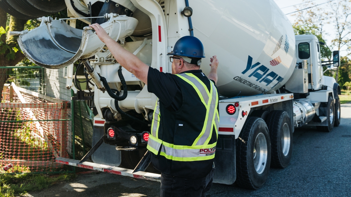Yard At A Time Concrete team standing in front of a ready-mix truck