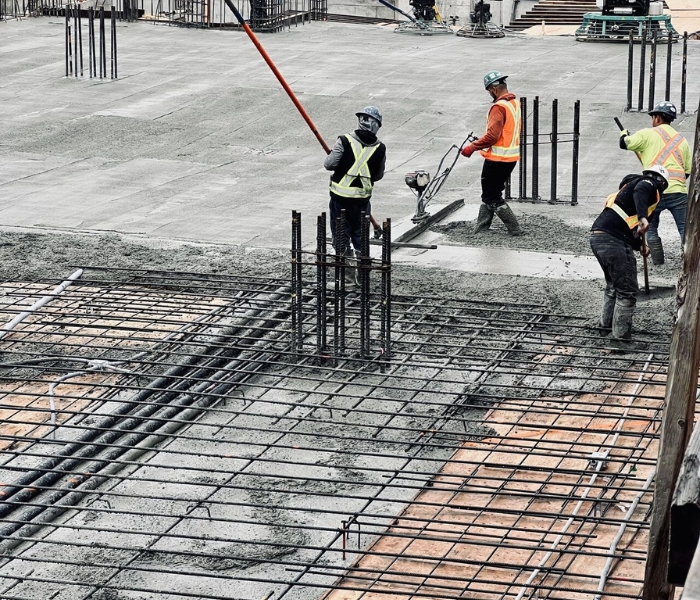 Concrete formwork in Vancouver construction site showing workers preparing reinforced slabs for concrete pour.