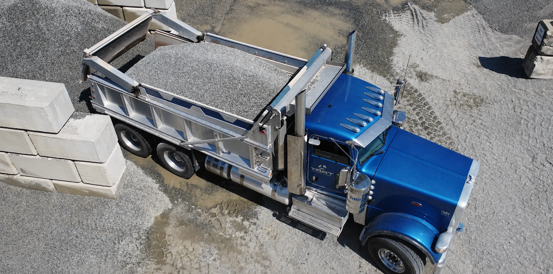 YAAT dump truck carrying aggregate material