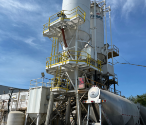 Concrete bathing plant cement silo and loading structure supplying ready-mix concrete to a mixer truck